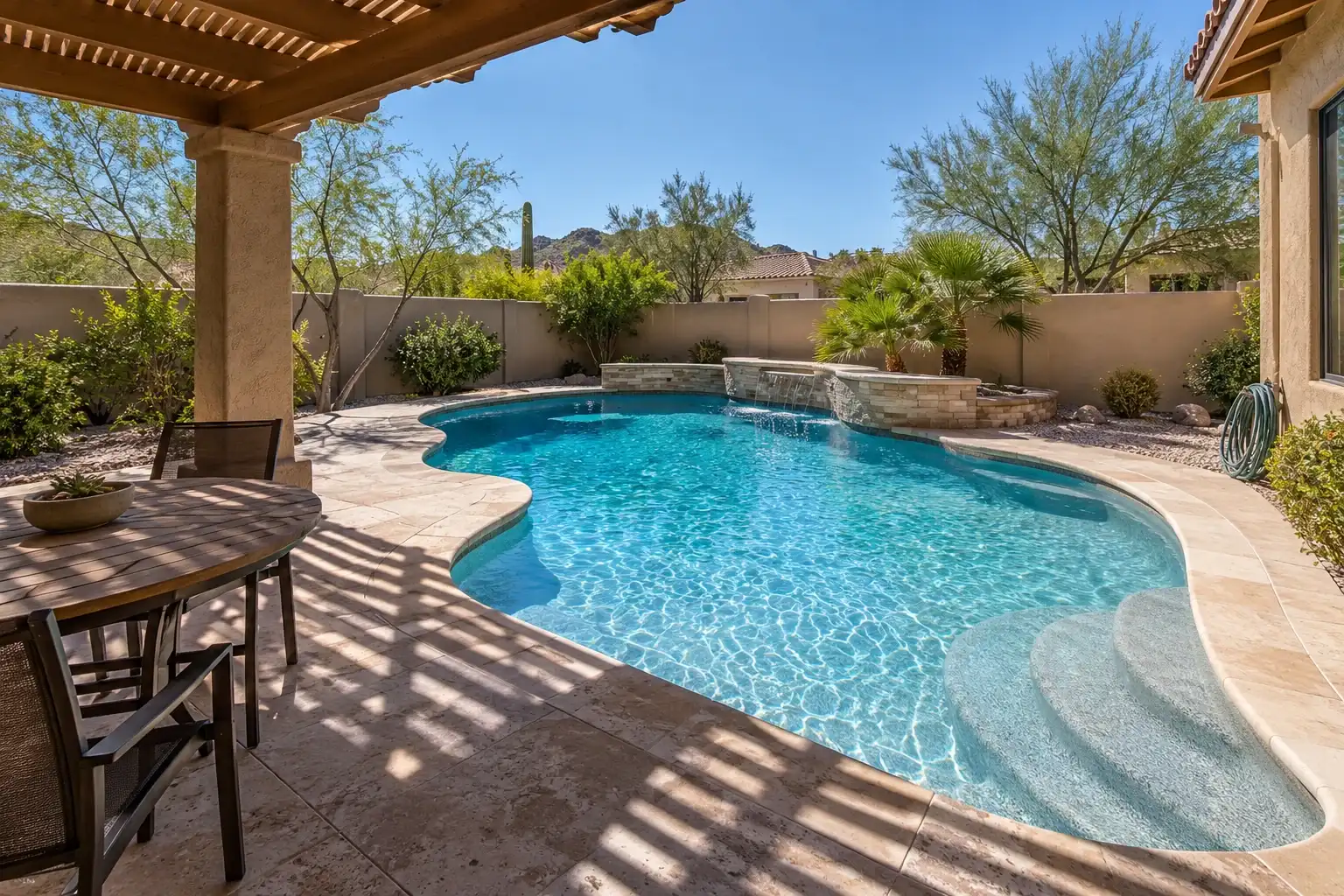 Family backyard pool with curved entry steps and striped shade from a wooden pergola